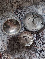 Top view of all three silver-plated pieces showing shapes and pierced designs