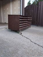 Perspective view showing louvered front and metal legs