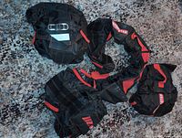 Four black and red Motomaster tire bags on floor