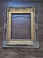 Front view of ornate gilded wood frame