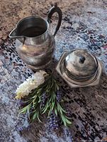 Pitcher beside lidded dish, top view