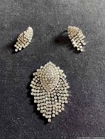 Front view of brooch and earrings displaying rhinestone pattern