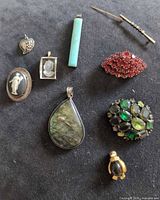 Group shot of all nine jewelry pieces arranged on black fabric