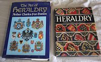 Front covers of both heraldry books showing titles and dust jackets