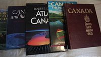 Five Canadian books standing side by side showing titles and spines