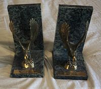 Front view of both marble bookends with brass eagles