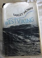 Front of book with dust jacket showing title and damage