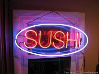 Photo of neon sushi sign illuminated, red and blue colors, 32 inches long