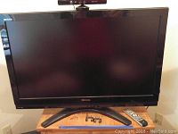 Front view of Toshiba 42 inch Regza flatscreen TV on wooden table, showing the screen and Toshiba branding.