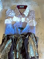 Stack of three shirts showing floral Hawes & Curtis, plaid Racing Green, brown Zara tunic