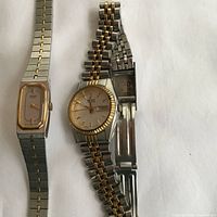 Front view of both Seiko wristwatches showing dial shapes, colours and bracelets