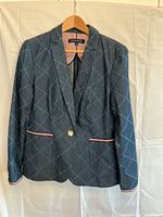 Front view of denim blazer on hanger