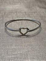 Entire bracelet laid flat showing heart centerpiece and band