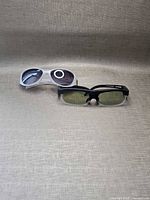 Both eyewear items side by side on fabric backdrop