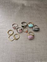 All eight rings laid out showing variety of styles and stones