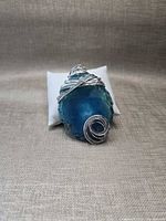 Front view of blue agate pendant in wire wrap
