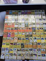 Overview of laid-out Pokémon cards covering tabletop
