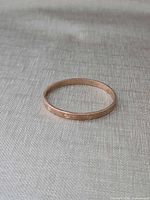 Bangle laid flat showing exterior screw motif