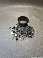 Pile of assorted sterling jewelry with cuff on top, shows mass and variety