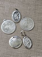 All five sterling silver pendants laid out