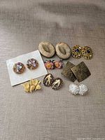 Group shot of all earrings and brooches
