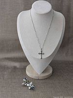 Full view of necklace displayed on bust with earrings below