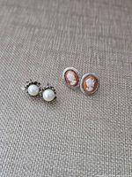 Both earring pairs side by side on fabric