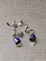 Overview of all earrings laid out on fabric background