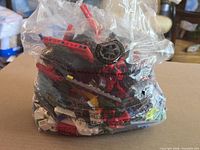 Bag of assorted LEGO Technic parts front view