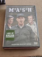 Front of sealed M*A*S*H Season 4 DVD box set showing cast and 3-disc set sticker