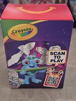 Front of Crayola Happy Meal box showing branding and graphics