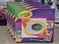 Front view of five sealed Crayola McDonald's toy boxes showing artwork and QR code