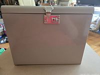 Front view of gray metal filing box showing chrome latch with key slot