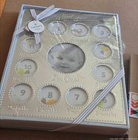 Front of sealed multi-opening silver picture frame showing design and ribbon