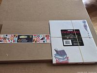 Overall view of sealed paper pad beside sealed pack of boards
