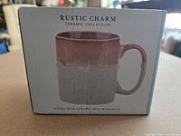 Front of retail box showing mug design and branding