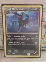 Front of sleeved Umbreon card showing set and condition