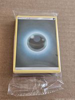 Front view of sealed Pokémon Darkness Energy card stack