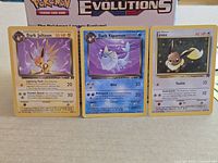 Front view of all three Team Rocket cards side by side