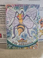 Front of Beedrill rainbow foil Topps card