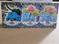 Group view of Bulbasaur #001, Ivysaur #002, Venusaur #003 Topps cards