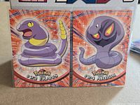Both Topps Pokémon cards Ekans #23 and Arbok #24 side by side