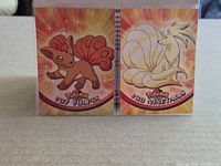 Both cards Vulpix #37 and Ninetales #38 side-by-side in sleeves