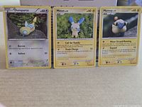 Front view of all three Pokémon cards showing overall condition and artwork