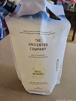 Front view of sealed 2 L refill pouch showing brand, product name, and cap
