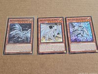Group shot of all three Yu-Gi-Oh Blue-Eyes cards