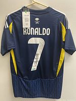 Full back view of jersey showing name, number, colors, Adidas stripes