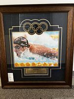 Full view of framed signed photo showing mat, frame, plaque, COA