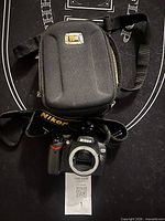 Camera body, strap, and carrying case overview