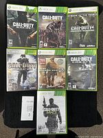 All seven Xbox 360 Call of Duty games laid out showing cover fronts